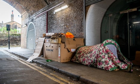 A cardboard shelter and tent for a homeless person under a railway arch in South London.