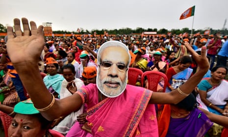 FILE PHOTO: A woman wearing a mask of PM Narendra Modi dances as she attends an election campaign rally being addressed by India’s ruling BJP President Amit Shah at Ahatguri villageFILE PHOTO: A woman wearing a mask of Prime Minister Narendra Modi dances as she attends an election campaign rally being addressed by India’s ruling Bharatiya Janata Party (BJP) President Amit Shah at Ahatguri village in Morigaon district in the northeastern state of Assam, India, April 5, 2019. REUTERS/Anuwar Hazarika/File Photo