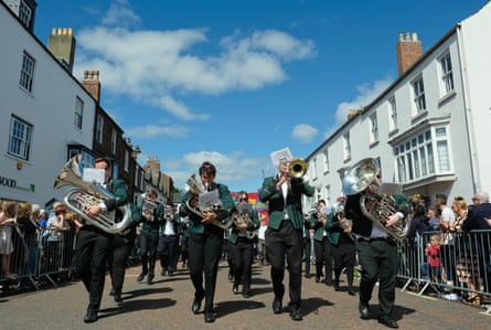 A brass band marches through the streets of Durham