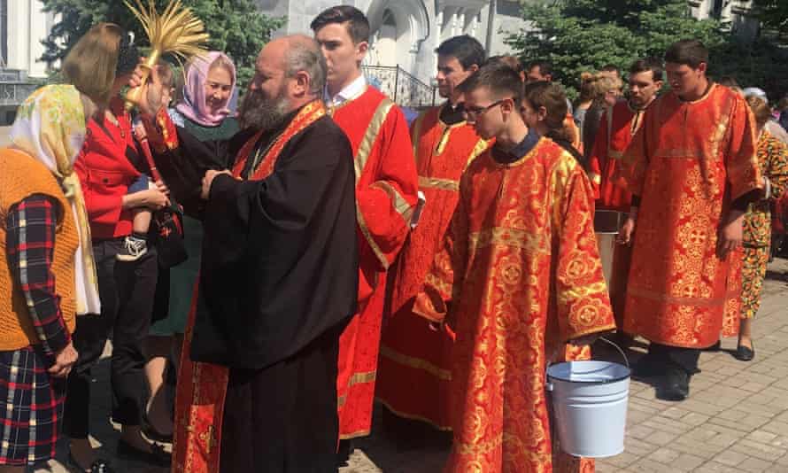 Clergy flick holy water over the faithful at Tashkent’s Cathedral of the Assumption