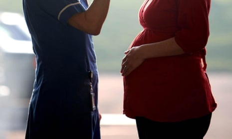 File photo of a midwife talking to a pregnant woman