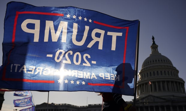 A Trump supporter waves a flag outside the US Capitol building on 14 November.