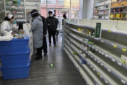 Empty shelves are seen in a pharmacy on 13 December 2022, as customers try to find medicine as Covid cases rise in Beijing.