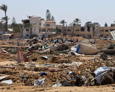 Displaced Palestinians inspect shelters damaged during an Israeli military operation in Deir Al-Balah, in the central Gaza Strip on Tuesday, 22 July 2025.