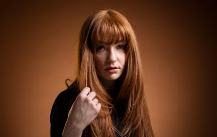 Nicola Roberts touching her long red hair