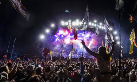 Revelers watch Paul McCartney perform at Glastonbury in June 2022.