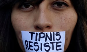 An activist with a sign pasted on her mouth urging to resist Bolivian government plans for stripping Tipnis of its protected status.