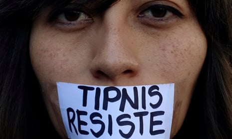 An activist with a sign pasted on her mouth urging to resist Bolivian government plans for stripping Tipnis of its protected status. 