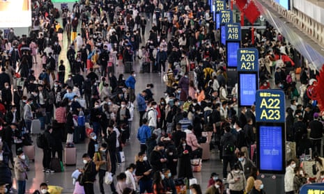 People wait for trains at Guangzhou South station in Guangdong province as they head to their home towns for lunar new year