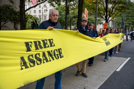 Protestors march around the Department of Justice while holding a Free Assange banner in Washington DC on 8 October.