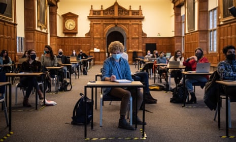 Masked students sit in a socially distanced class at the University of Oxford