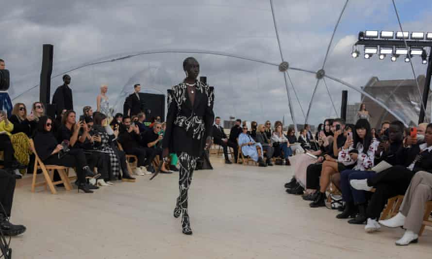 A bejewelled model walks the runway.