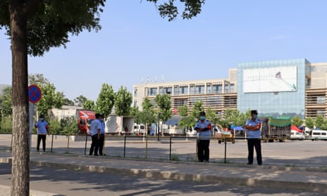 Security staff members patrol an entrance to the Xinfadi wholesale market, in Beijing, where a new coronavirus cluster has been reported.