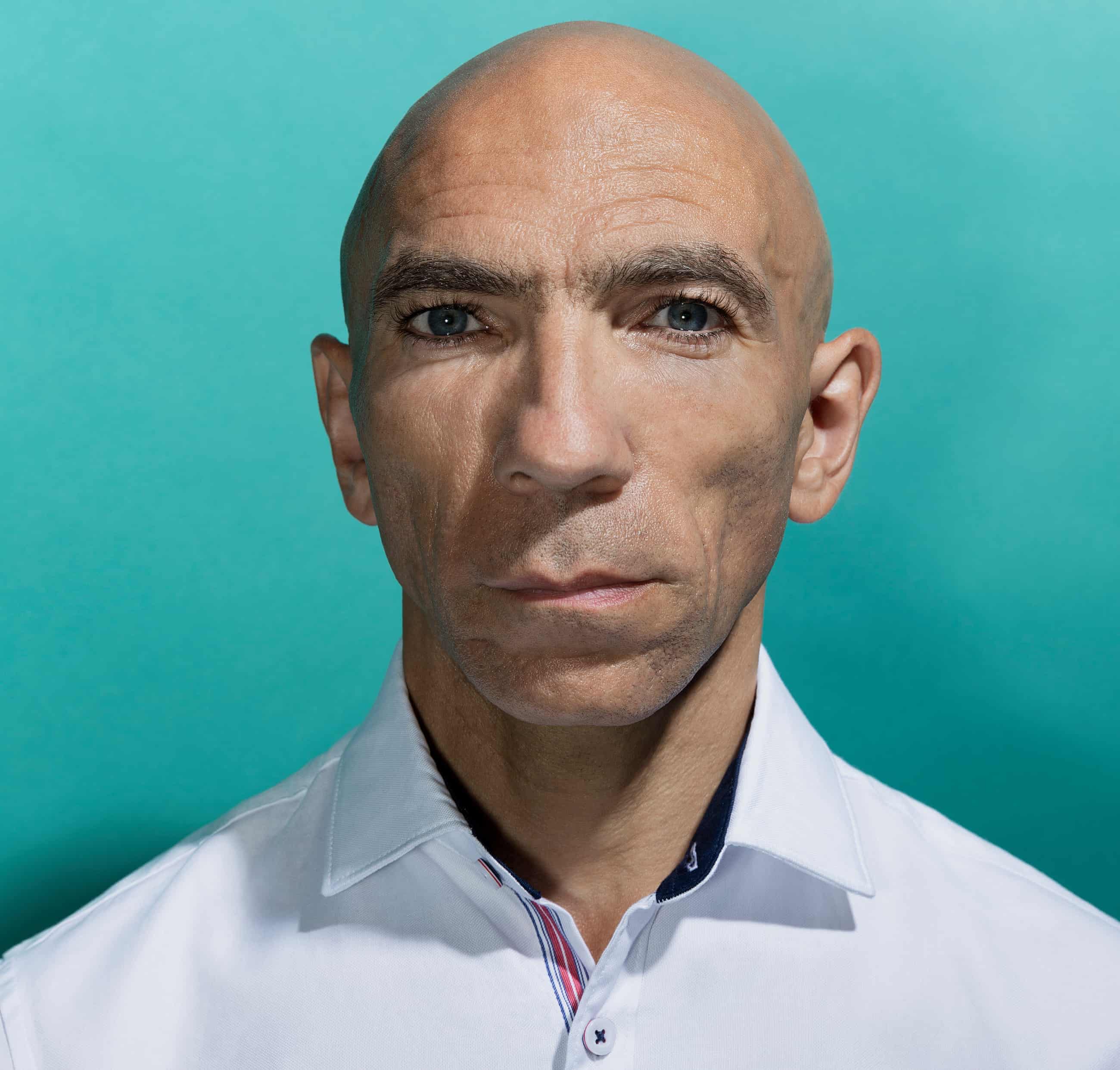 Head shot of actor and director Anthony Ekundayo Lennon against turquoise background