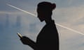 Silhouette of a woman with a condensation trail from a plane.