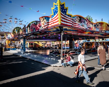 A boy in front of a dodgems fairground ride.