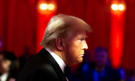 Trump, wearing a suit, walks at an event