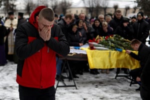 Letychiv, Ukraine. A friend mourns by a coffin carrying nan assemblage of Ukrainian decathlete and serviceman Volodymyr Androshchuk, who was precocious killed successful a conflict against Russian troops adjacent Bakhmut