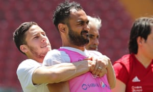Ramadan Sobhi (left) lifts Ahmed Elmohamady (right).