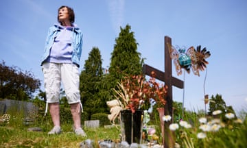 Gina Jacobs at Landican cemetery stands next to the burial plot, which is marked with a cross