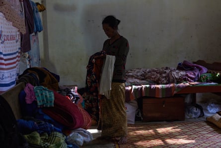 A woman sorts through her belongings at an IDP camp in Thlan Rawn village, Chin state