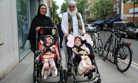 Two-year-olds Safa and Marwa Ullah leaving hospital, with their mother Zainab Bibi and their grandfather Mohammad Sadat, after successful surgery at Great Ormond Street hospital in London, to separate their heads.