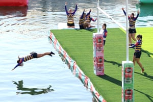 Woman dives into water, while others cheer