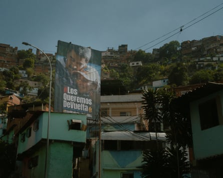 A billboard with Nicolas Maduro and Cilia Flores’s faces saying 'We want them back'