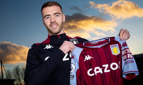Calum Chambers poses with an Aston Villa shirt on Thursday after signing from Arsenal.