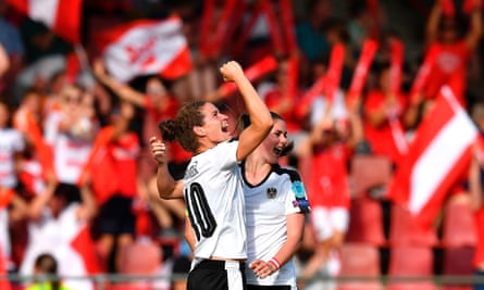 Austria’s Nina Burger, left, celebrates with team-mate Sarah Zadrazil after opening the scoring against Switzerland.