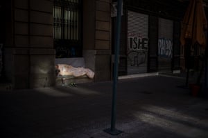 Barcelona, SpainA woman sleeps in an empty street where bars and shops were closed due to the restrictions imposed by the government to contain the spread of Covid-19.