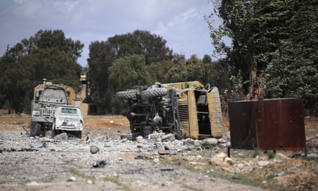 Debris and an overturned military vehicle