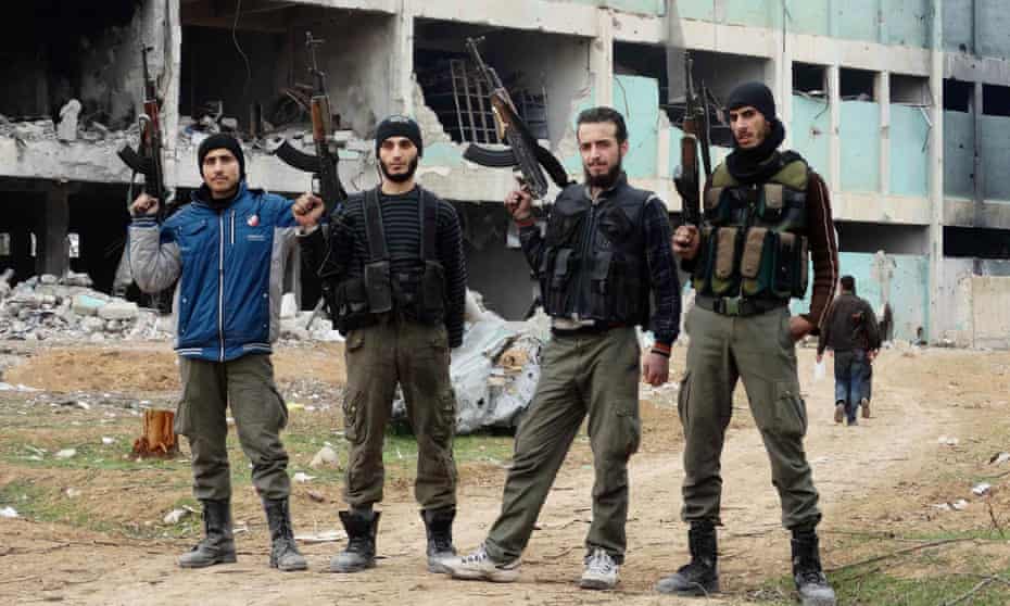 Free Syrian Army fighters pose with their weapons in eastern al-Ghouta, near Damascus.