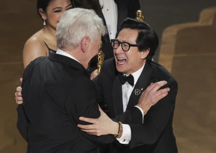 Ke Huy Quan looks ecstatic to be reunited with Harrison Ford on stage at the 2023 Oscars