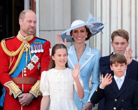 The Prince and Princess of Wales and their three children wave to a crowd.