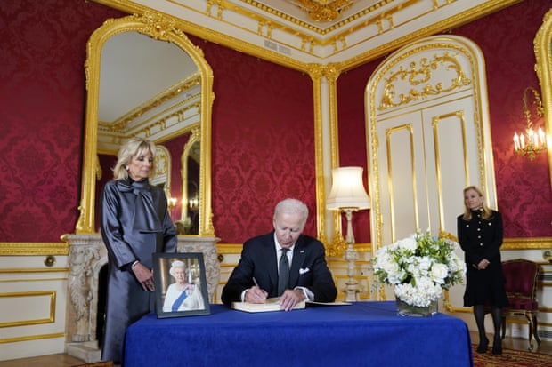 President Joe Biden signs a book of condolence at Lancaster House in London.