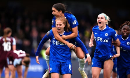 Chelsea's Sam Kerr jumps on Sjoeke Nüsken’s back after the latter's goal during the Women’s Super League against Aston Villa