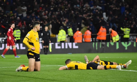 Wolverhampton Wanderers players look dejected after Liverpool’s Divock Origi scored their late goal.