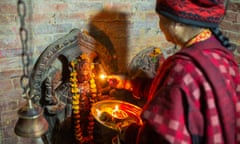 Bal Kumari Shrestha worships the returned statue of Laxmi and Narayan at the temple of Laxmi Narayan in Lalitpur.