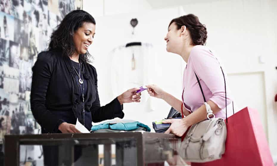 Woman paying with a card in a shop