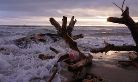 A football under uprooted trees on the Pinedo beach in Valencia.