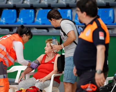 An older woman receives medical help.