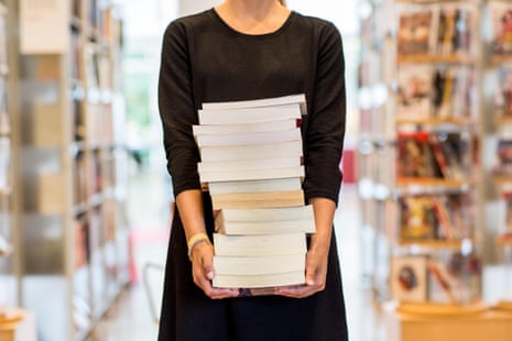 Woman holding stack of books