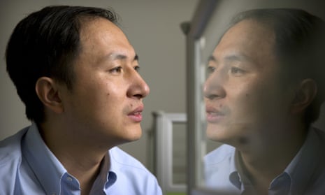 He Jiankui is reflected in a glass panel in a lab in Shenzhen, China