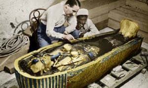 The British archeologist Howard Carter and an Egyptian assistant examine the sarcophagus containing the body of the pharaoh Tutankhamun in the Valley of the Kings, Egypt.