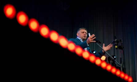 Robert Fico speaking at an event with stage lights in front of him