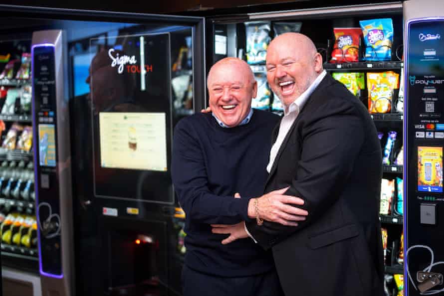John Broderick Sr (left) and his son Johnny in the warehouse of their vending machine business in Manchester.
