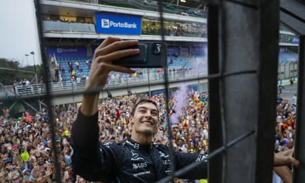 Mercedes’ George Russell takes a selfie with fans after winning the Brazilian Grand Prix