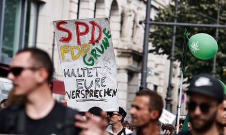 People demonstrating last month in Berlin, Germany, with a placard calling on the three parties of the governing coalition to fulfil their pledges on the legalisation of cannabis