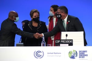The president of the UN general assembly, Abdulla Shahid (left), shakes hands with the Cop26 president, Alok Sharma, during the opening ceremony